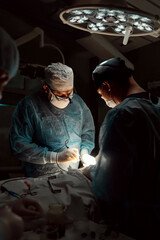 The surgeon is working hard in the operating room