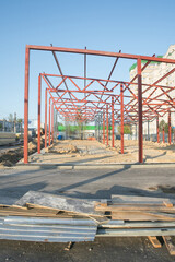 Construction site for a new building with exposed steel frame in an urban area during daylight hours