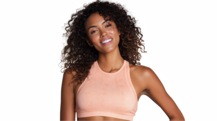 Confident and fit, a sporty woman with curly hair smiles broadly while posing with her hand on her hip against a transparent background, showcasing her athletic attire and positive attitude