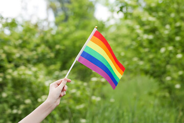 Teenager Holds Rainbow Flag LGBT in his Hands. Pride Month. Lesbian Gay Bisexual Transgender. Love, human rights, tolerance