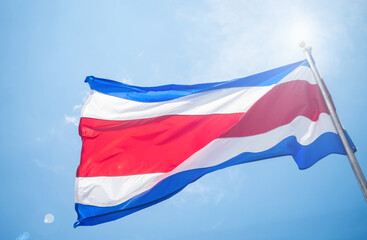 The national flag of Costa Rica flies in the wind on a sunny day, symbolizing freedom, peace, and national pride.