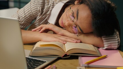 Sleeping tired woman exhausted American Latina ethnic girl weary lazy female high school student overworked businesswoman relax nap on table boring studying at home kitchen sleep napping close eyes
