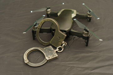 Remote-controlled drone with handcuffs close-up