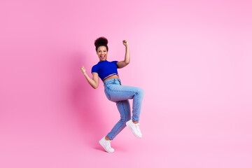 Energetic Young Woman Dancing in Casual Fashion Against a Pink Background Exhibiting Joyful...