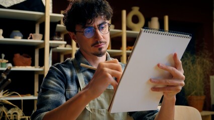 Caucasian man guy artist painting notebook sketch paper drawing male painter designer sculptor...