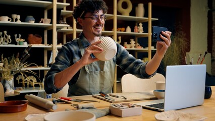 Small business owner Caucasian man guy artist potter salesman blogger influencer mobile phone photo male sculptor craft sale online blog ceramics sell online social media handmade in pottery workshop