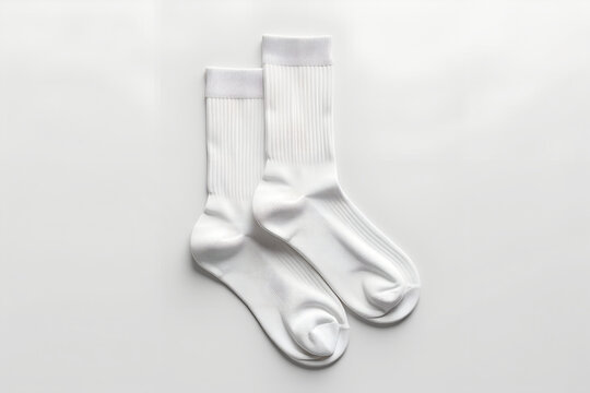 Pair of clean white socks mockup, laid flat, top-down view, natural fabric texture, plain white background