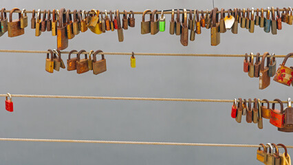 Many Old Rusty Love Padllocks Locked at Bridge Fence Wires Over Water
