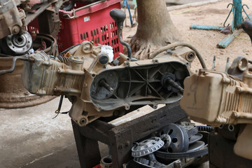The ATV engine is disassembled for repair at the engine repair center in the business. ATV engine parts, three-speed automatic system.