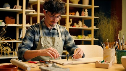 Caucasian man guy male sculptor potter art designer architect decorator craftsman holding measuring...
