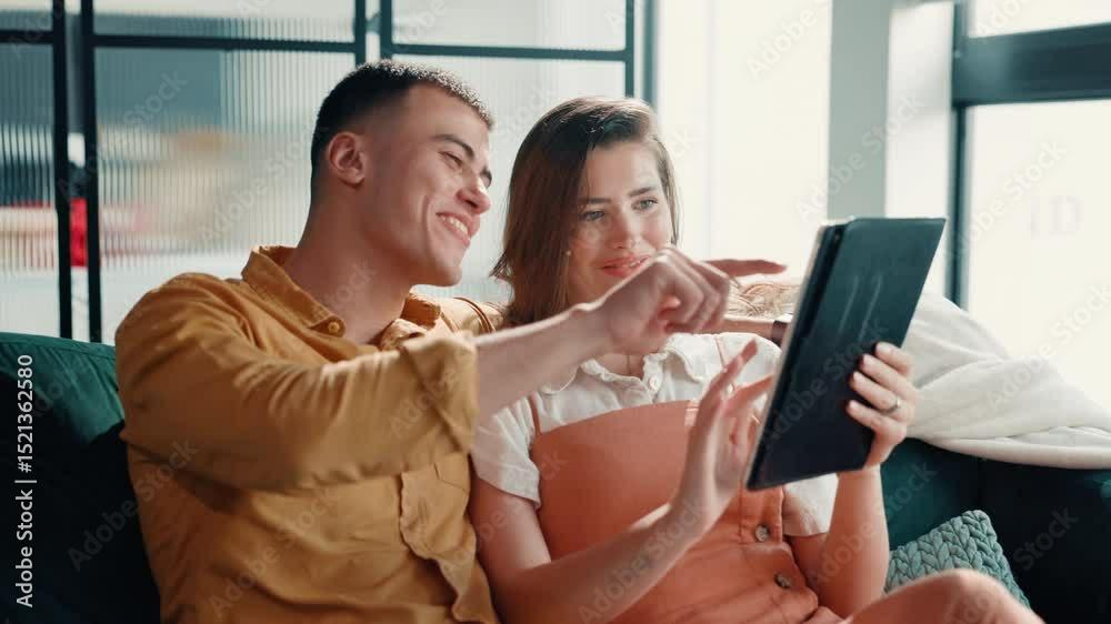 Poster couple, laughing or pointing to tablet on sofa for online shopping, app choice or web browsing. rela