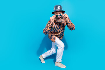 Glamorous Positive Stylish Senior Gentleman Striking a Playful Pose in Trendy Party Attire