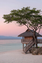 serene paradise beach featuring charming treehouse at sunset