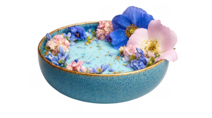 Turquoise spirulina smoothie bowl decorated with colorful edible flowers including blue, pink and purple petals with gold flakes on a transparent background