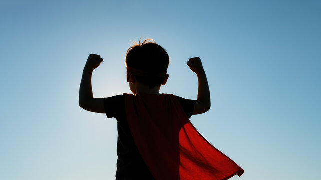 Child superhero silhouette strong powerful sky