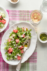 A light appetizer or an elegant side dish. Salad made with arugula, feta, pieces of watermelon and cucumber. Delicate flavor.