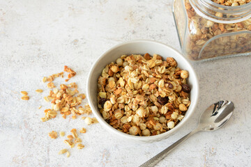 Bowl of delicious and crunchy granola for breakfast with a teaspoon top view
