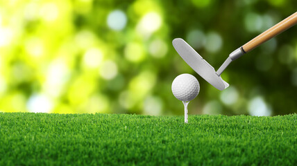 Golf ball on green grass and club outdoors, closeup