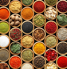 Set of different aromatic spices in bowls on black background, flat lay