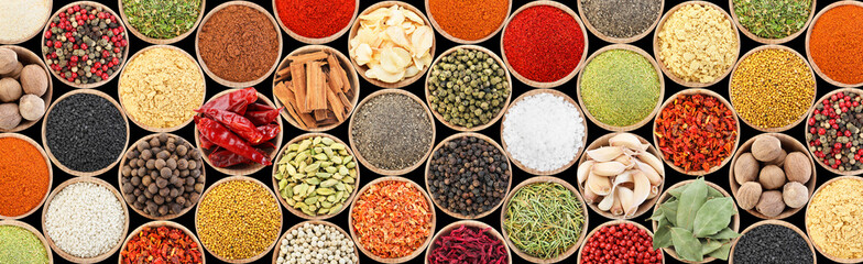 Set of different aromatic spices in bowls on black background, flat lay. Banner design