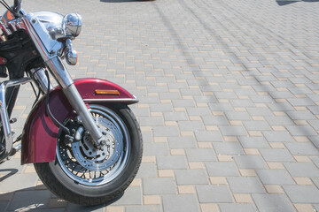 Motorcycle parked on a paved surface under bright sunlight during the day