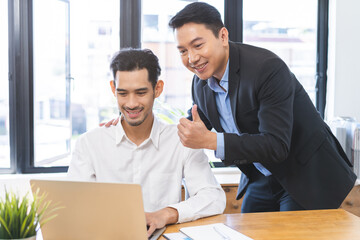 Congratulating, confidence two colleague asian businessman, male encourage staff for done excellent work. Boss showing thumbs up to do very good job. Leadership of team support. Trust of supervisor.