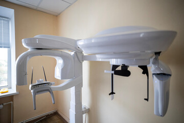 A modern X-Mind Prime panoramic dental X-ray machine, an orthopantomograph, displays a digital dental image on its monitor in a clinic setting.