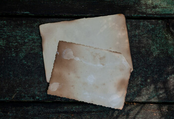 Two vintage empty papers lies on the old wooden background
