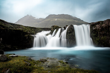 View to the Kirkjufell waterfall at summer. Kirkjufellsfoss waterfall, Iceland, Europe.