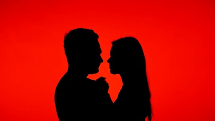 Silhouette of Couple in Romantic Red Lighting Background
