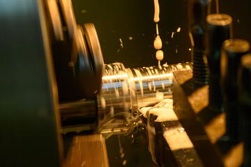 The lathe machine finish cut metal shaft parts with liquid coolant method.