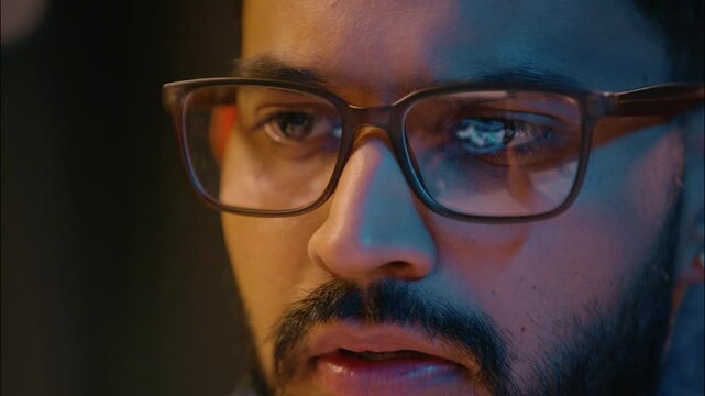 Close up business man trader wearing glasses Indian businessman working computer screen stock market charts bitcoin data analysis eyeglasses reflection male guy broker online crypto currency trading - Powered by Adobe