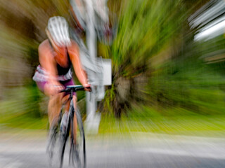 Naklejka premium Blurry outline of an unrecognizable person riding on nature trail