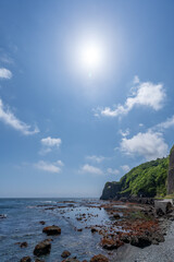 Obraz premium Scenery landscape of blue sky and sea seen from Hakodate Esan line of narrow road along the coastal cliffs in Hokkaido, Japan