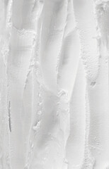 Creamy white texture forming vertical wavy patterns resembling smooth ice cream, perfect for...