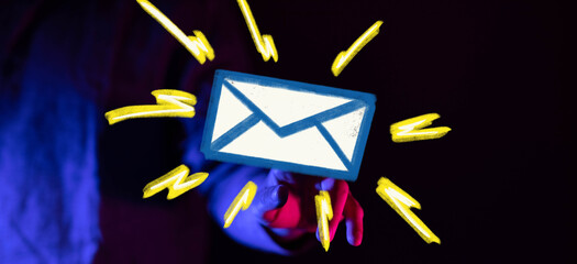 Stock photo of a hand reaching for an email icon, signifying urgent communication.