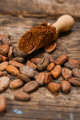 Cacao Beans and Cocoa Powder on Rustic Wooden Background with Natural Texture

