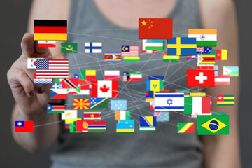 A hand interacts with a network of flags, representing global connections and international...