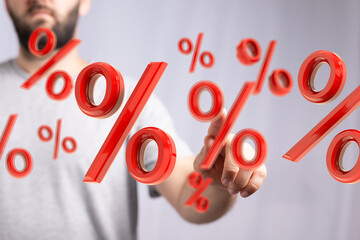 Person interacts with 3D percentage symbols, representing interest rates, discounts, financial...