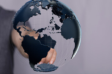 Abstract image of a hand interacting with a 3D model of Earth, representing global connectivity and...