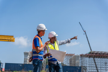 Construction Workers Planning Infrastructure Development, Engineers Discussing Project Progress at Construction Site, Civil Engineers in Safety Gear at Industrial Building Site