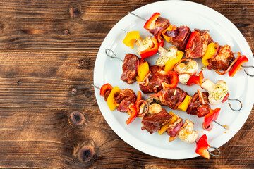 Metal skewers with raw meat.