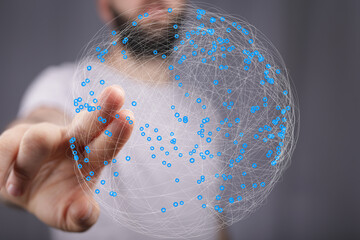 Hand interacting with a digital sphere representing global network connections and data flow.