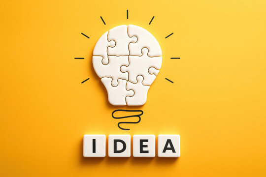 A concept innovation and creativity formed by interconnected puzzle pieces shaped like a light bulb symbolizes the process generating new ideas in business