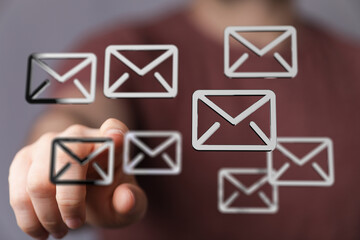 Person interacts with email icons, showcasing efficient inbox management and digital communication.