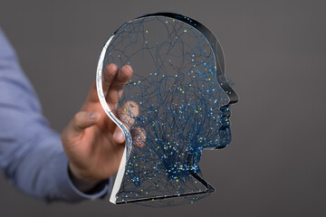 Stock photo of a hand interacting with a digital brain, representing AI, neural networks, and...