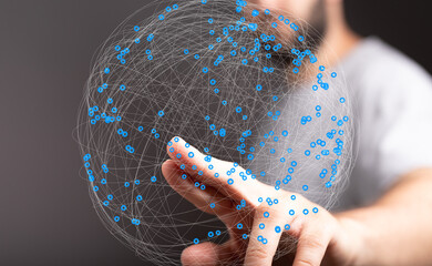 Abstract image of a hand interacting with a digital sphere representing global network connections...