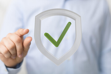 High-quality image of a person clicking a check mark inside a shield, symbolizing data security and...