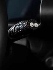 Close up of mini figures of black funny characters in car interior