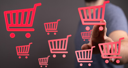 Person interacts with digital shopping carts, symbolizing online retail and e-commerce.